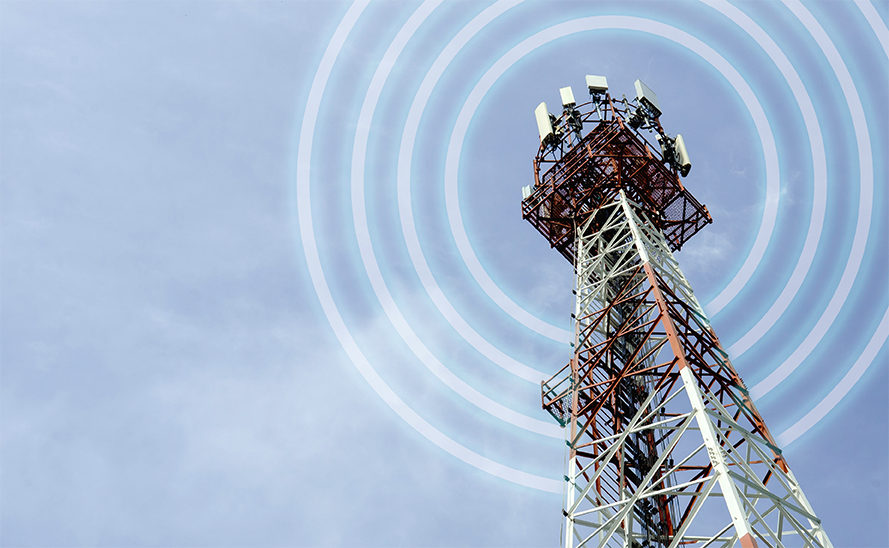 Photo taken from the bottom of a cell tower with signal around it